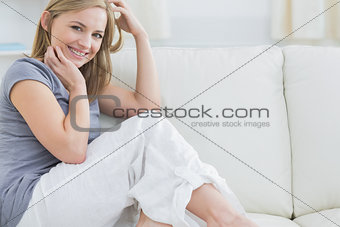 Portrait of smiling woman sitting on couch