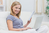 Casual woman with laptop and book in living room