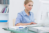 Female executive working on computer at office
