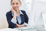 Confident business woman with computer at office desk