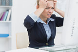 Frustrated business woman in front of computer at office desk