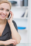Closeup of smiling business woman using cellphone