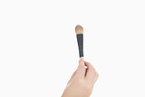 Closeup of hand holding makeup brush