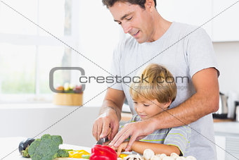 Father and son preparing vegetables together