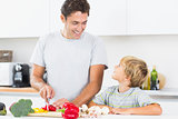 Father preparing vegetables with son