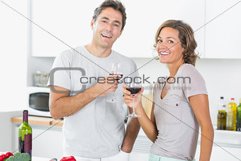 Smiling couple enjoying red wine together