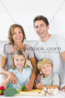 Smiling family preparing vegetables
