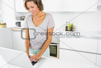 Happy woman using laptop