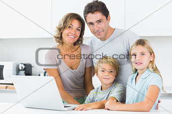 Smiling family with laptop