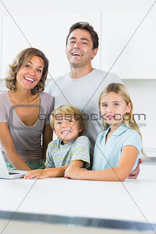 Cheerful family standing in kitchen