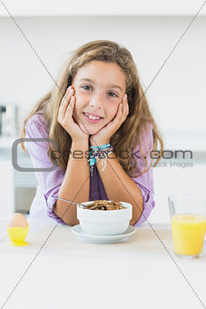 Happy girl at breakfast