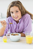 Young girl having cereal for breakfast