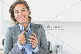 Smiling woman holding coffee mug