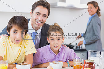 Father and children having breakfast