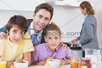 Father and children at breakfast