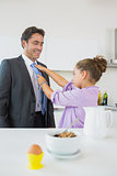 Daughter fixing fathers tie