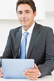 Man in suit using tablet
