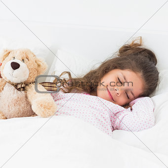 Little girl sleeping with teddy bear