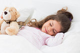 Cute girl asleep with teddy bear