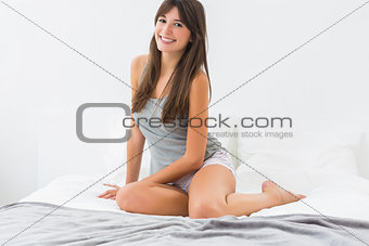 Smiling woman on bed