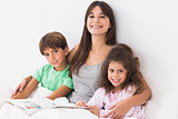 Mother with son and daughter reading book