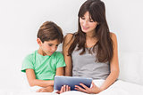 Mother and son using tablet pc