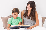 Mother and son reading in bed