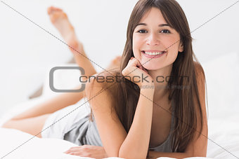 Happy woman lying in bed