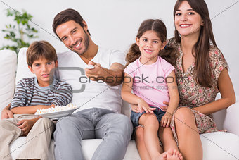 Happy family watching television together