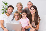 Happy family on couch using laptop