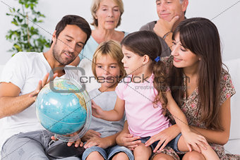 Happy family looking at globe