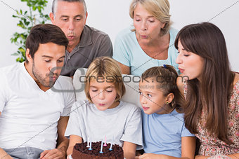 Little boy blowing out birthday candles