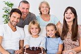 Smiling family with birthday cake