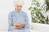 Elderly woman reading a old book