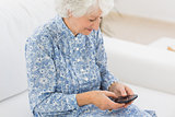 Elderly cheerful woman using a smartphone
