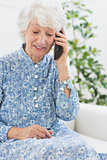 Elderly cheerful woman on a mobile phone