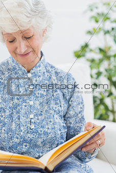 Elderly woman looking at her album