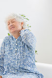Elderly woman suffering with a neck pain