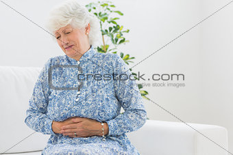 Elderly woman having a belly pain