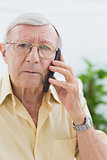 Unhappy elderly man on the mobile phone