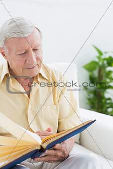 Elderly man watching his pictures