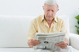 Elderly concentrated man reading newspapers
