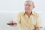 Elderly man using the remote