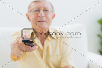 Concentrated elderly man using the remote