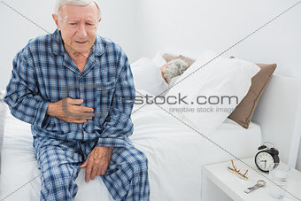 Elderly man suffering with belly pain