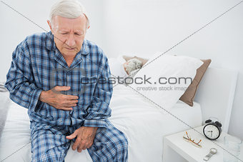 Aged man suffering with belly pain