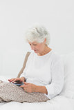 Old woman using a digital tablet