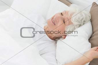 Smiling old woman sleeping