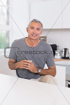 Smiling man holding a cup