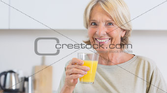 Mature woman drinking orange juice